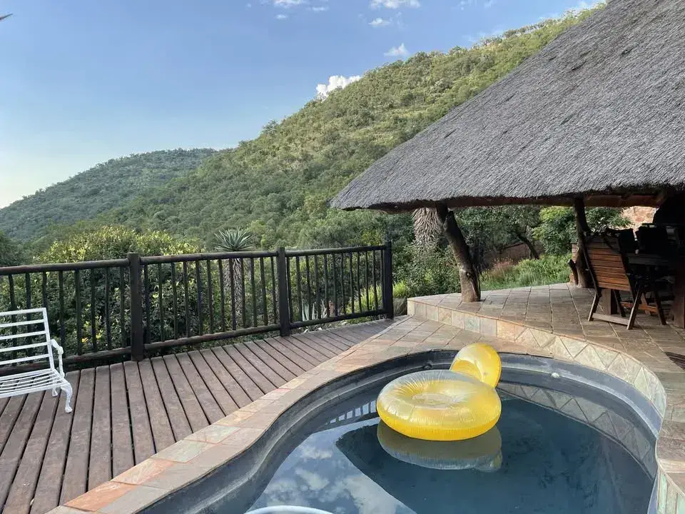 Paurosa lodge terrace and pool overlooking green mountain scenery